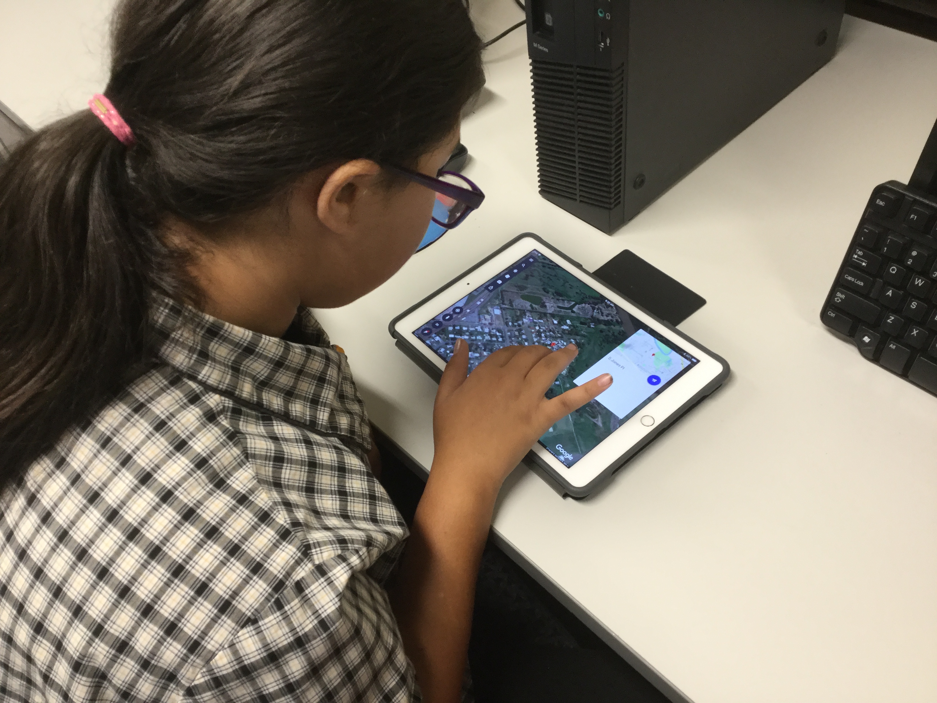 Student working on iPad on desk